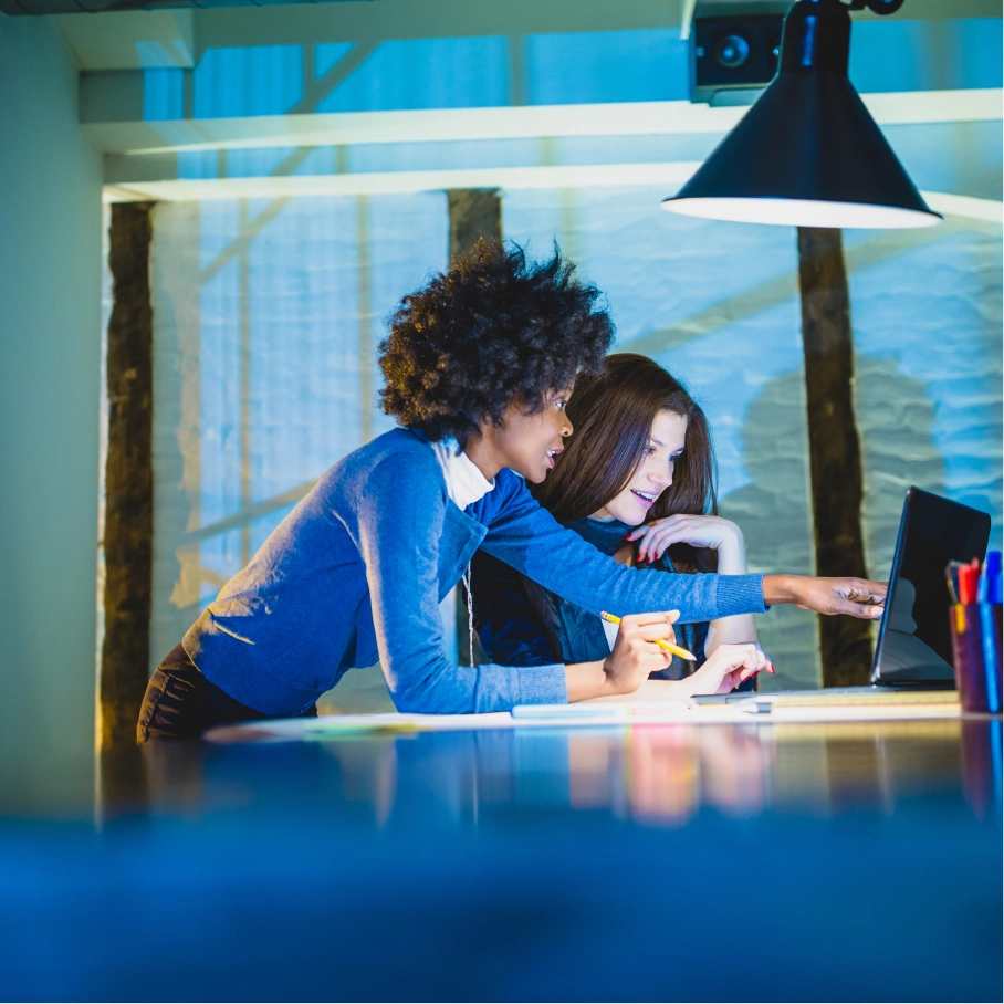 Person in blue sitting on green field